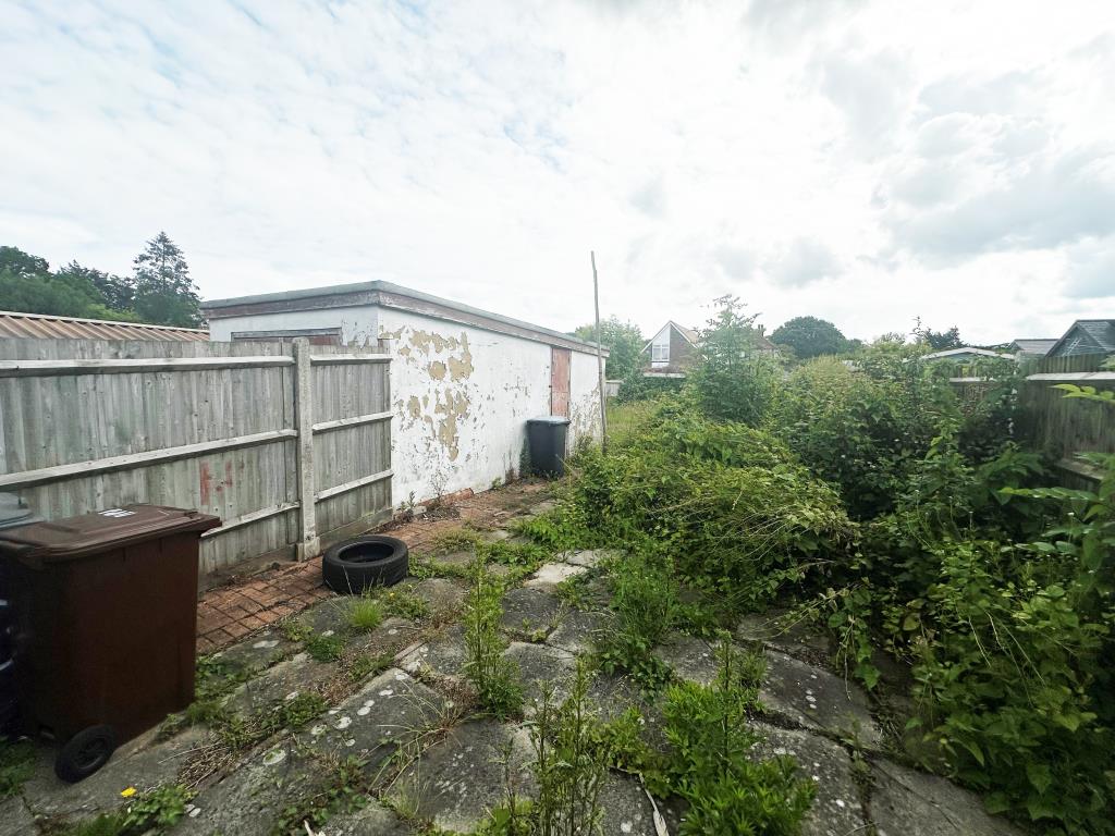 Lot: 157 - CHALET BUNGALOW FOR REFURBISHMENT POTENTIAL FOR EXTENSION - Garden with garage